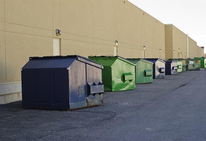 a large dumpster awaits materials from a renovation project in Baileyton